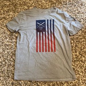 Grey, blue, and red Under Armour shirt.